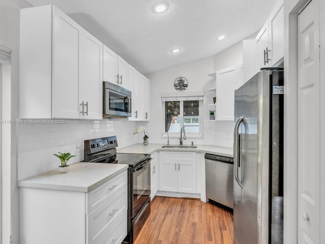 2810 River Run Cir E, Miramar, FL 33025 - kitchen with stainless steel appliances, a sink, open shelves, a textured ceiling, and decorative backsplash