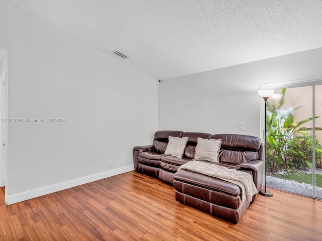 2810 River Run Cir E, Miramar, FL 33025 - living area with wood finished floors, baseboards, and a textured ceiling