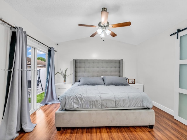 2810 River Run Cir E, Miramar, FL 33025 - bedroom with a barn door, lofted ceiling, wood finished floors, ceiling fan, and access to outside