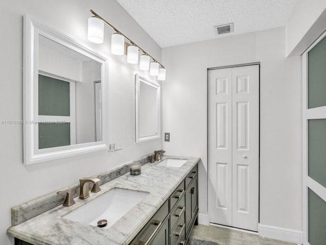 2810 River Run Cir E, Miramar, FL 33025 - bathroom with double vanity, a closet, a textured ceiling, and baseboards