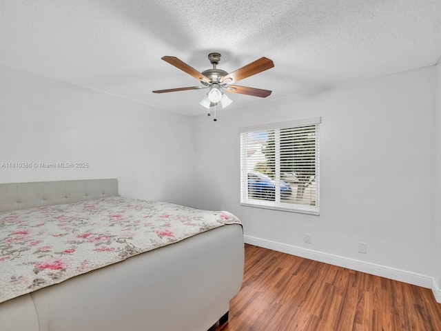 2810 River Run Cir E, Miramar, FL 33025 - bedroom with wood finished floors, baseboards, a textured ceiling, and ceiling fan