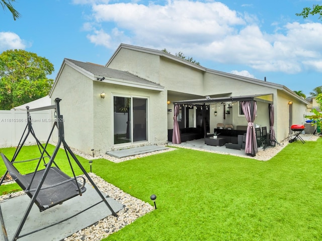 2810 River Run Cir E, Miramar, FL 33025 - back of property featuring an outdoor living space, a patio area, stucco siding, and a yard