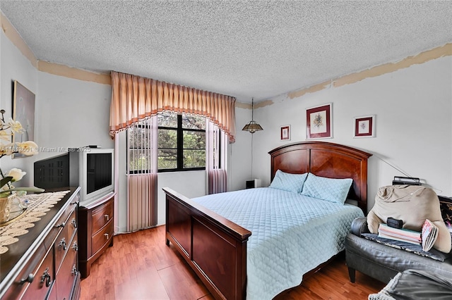 6195 Rock Island Rd Unit 215, Tamarac, FL 33319 - bedroom featuring a textured ceiling and light wood-style flooring