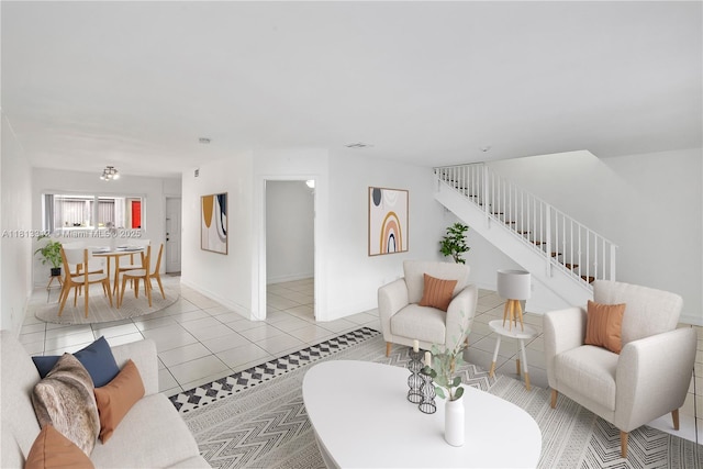 7342 Gary Ave, Miami Beach, FL 33141 - living room featuring stairs, light tile patterned flooring, and baseboards