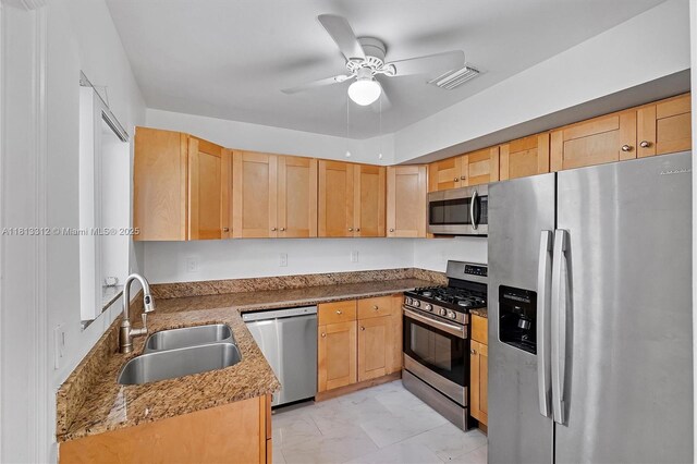 7342 Gary Ave, Miami Beach, FL 33141 - kitchen with appliances with stainless steel finishes, a sink, light marble finish floors, light brown cabinets, and ceiling fan