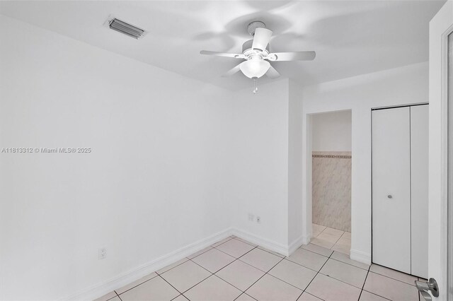 7342 Gary Ave, Miami Beach, FL 33141 - unfurnished bedroom featuring light tile patterned flooring, baseboards, and a ceiling fan