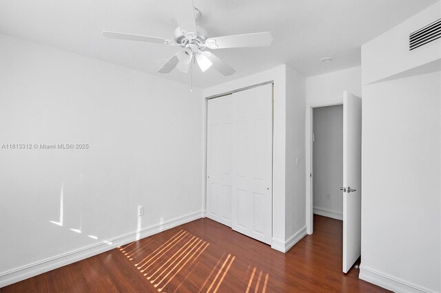 7342 Gary Ave, Miami Beach, FL 33141 - unfurnished bedroom with wood finished floors, a closet, a ceiling fan, and baseboards