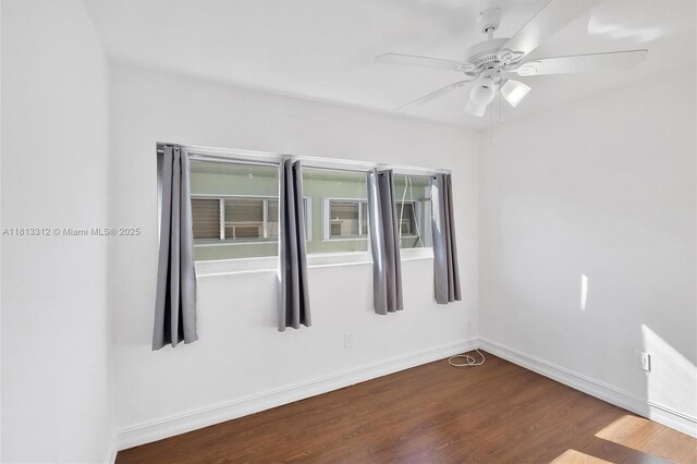 7342 Gary Ave, Miami Beach, FL 33141 - empty room featuring dark wood-type flooring, baseboards, and a ceiling fan