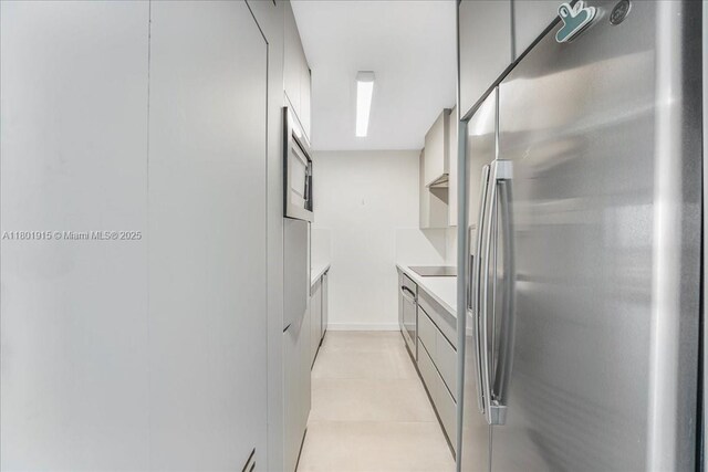 1865 79th St Unit 12G, North Bay Village, FL 33141 - kitchen featuring freestanding refrigerator, modern cabinets, light countertops, and black electric cooktop