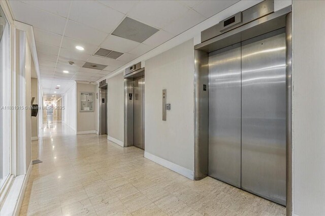 1865 79th St Unit 12G, North Bay Village, FL 33141 - hall featuring elevator, a paneled ceiling, and recessed lighting