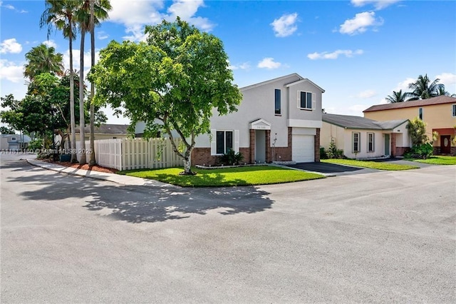 14100 Langley Pl, Davie, FL 33325 - townhome / multi-family property featuring a garage, stucco siding, brick siding, and driveway