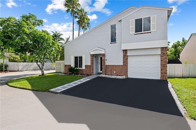 14100 Langley Pl, Davie, FL 33325 - view of front of house with brick siding, asphalt driveway, an attached garage, and stucco siding