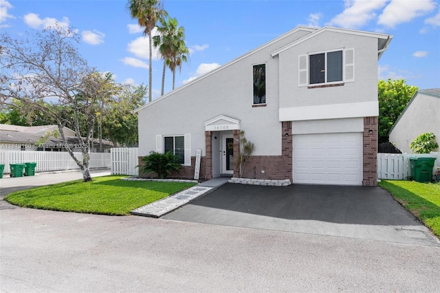 14100 Langley Pl, Davie, FL 33325 - view of front of property featuring brick siding, driveway, a garage, and stucco siding