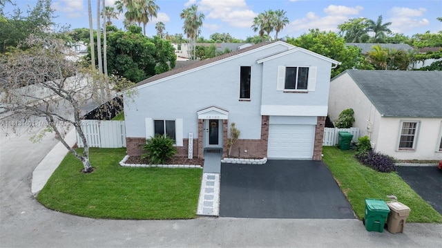 14100 Langley Pl, Davie, FL 33325 - view of front of property featuring brick siding, asphalt driveway, a garage, and stucco siding