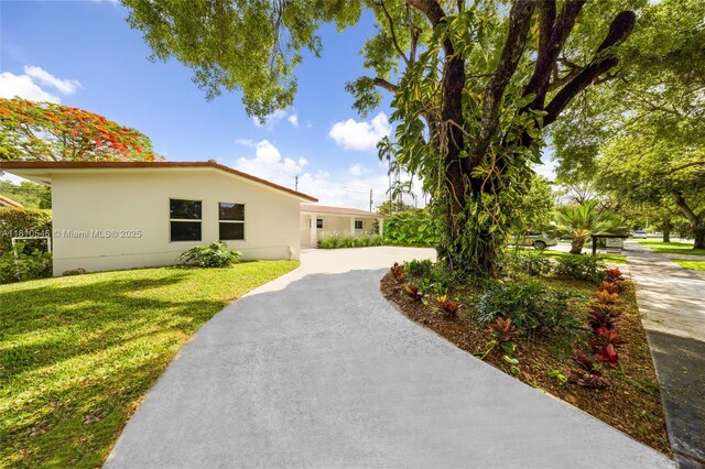1237 Dove Ave, Miami Springs, FL 33166 - kitchen with freestanding refrigerator, a center island, light wood-style flooring, light stone countertops, and a ceiling fan
