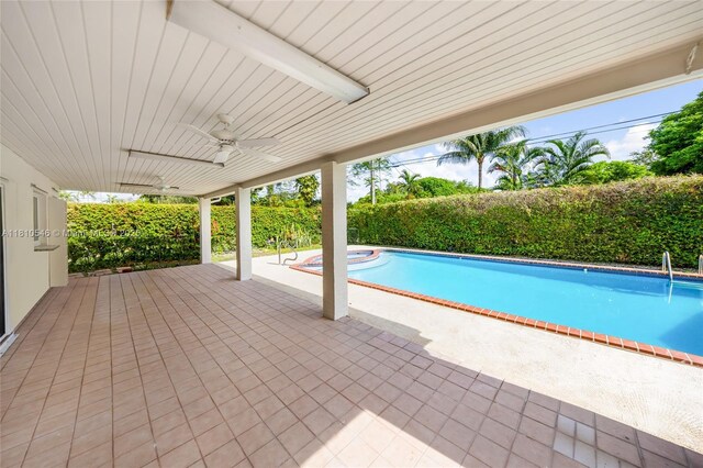 1237 Dove Ave, Miami Springs, FL 33166 - view of pool featuring a storage shed, a patio area, a fenced backyard, ceiling fan, and an in-ground hot tub