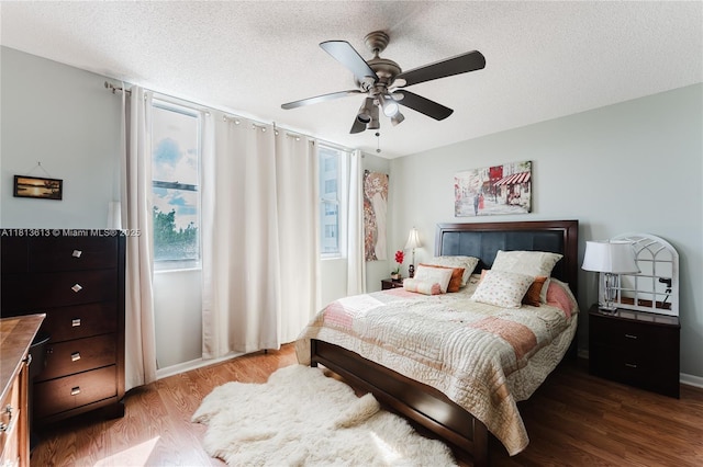 4330 Hillcrest Dr Unit 505, Hollywood, FL 33021 - bedroom featuring wood finished floors, a textured ceiling, a ceiling fan, and baseboards