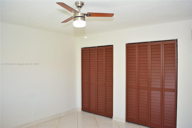 705 NE 2nd St Unit 4, Hallandale Beach, FL 33009 - unfurnished bedroom with two closets, light tile patterned floors, ceiling fan, and baseboards