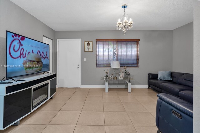 8401 SW 107th Ave Unit 117E, Miami, FL 33173 - living room featuring baseboards, a chandelier, and light tile patterned floors