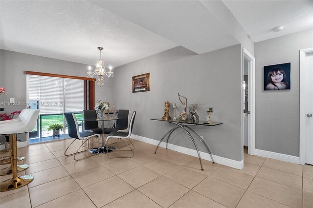 8401 SW 107th Ave Unit 117E, Miami, FL 33173 - tiled dining space featuring a chandelier, baseboards, and a textured ceiling
