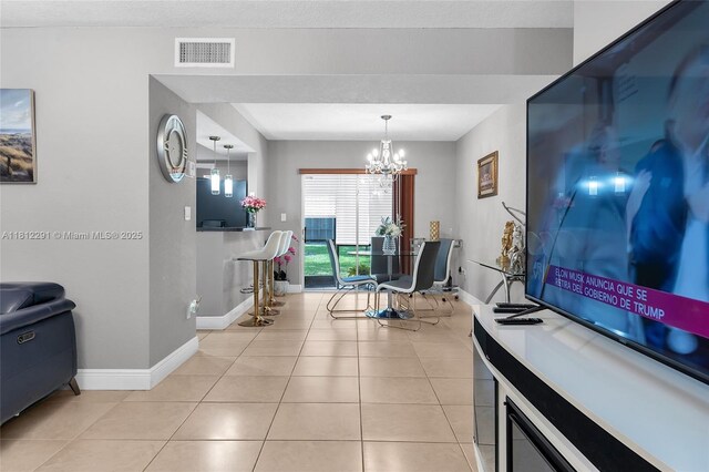 8401 SW 107th Ave Unit 117E, Miami, FL 33173 - living area with baseboards, a chandelier, and light tile patterned floors