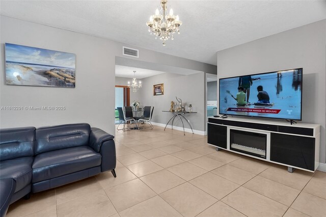 8401 SW 107th Ave Unit 117E, Miami, FL 33173 - living area with a chandelier, light tile patterned floors, baseboards, and a textured ceiling