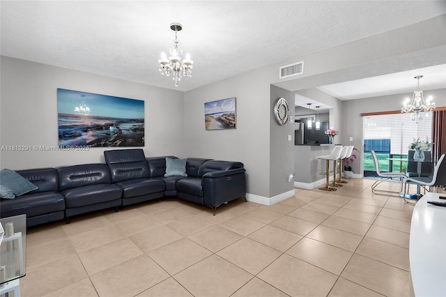 8401 SW 107th Ave Unit 117E, Miami, FL 33173 - living room featuring a chandelier, light tile patterned floors, baseboards, and a textured ceiling