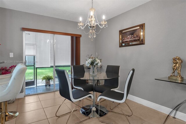 8401 SW 107th Ave Unit 117E, Miami, FL 33173 - dining room featuring a chandelier, light tile patterned flooring, and baseboards