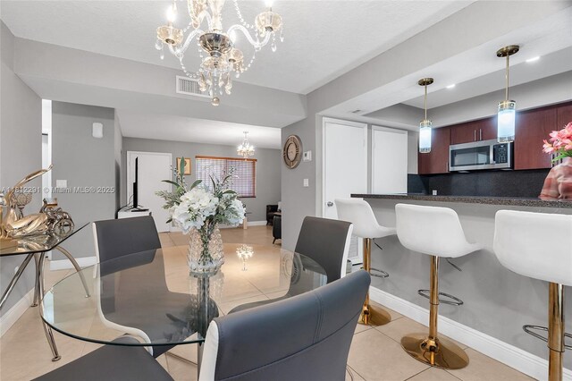 8401 SW 107th Ave Unit 117E, Miami, FL 33173 - dining area with a chandelier, baseboards, light tile patterned flooring, and a raised ceiling