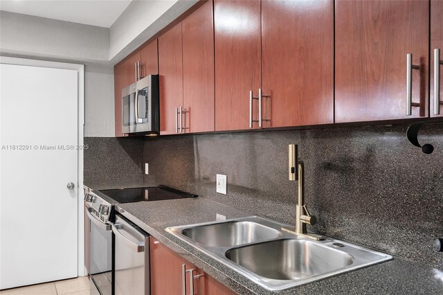 8401 SW 107th Ave Unit 117E, Miami, FL 33173 - kitchen with appliances with stainless steel finishes, dark countertops, a sink, and decorative backsplash