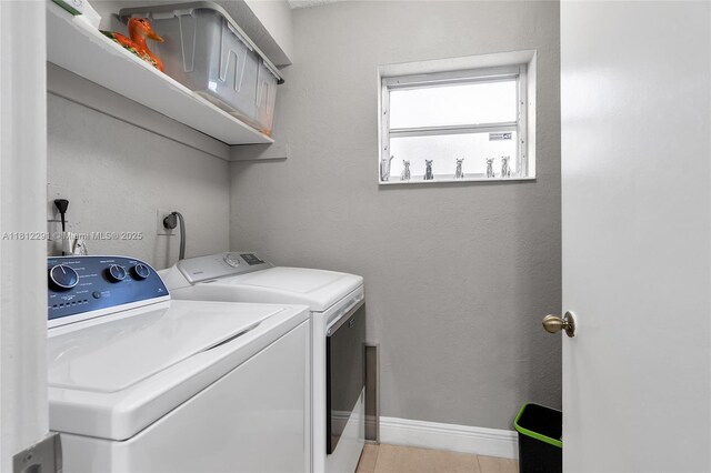 8401 SW 107th Ave Unit 117E, Miami, FL 33173 - laundry area with washer and clothes dryer, light tile patterned floors, and baseboards