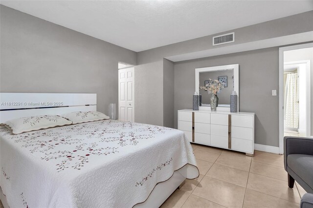 8401 SW 107th Ave Unit 117E, Miami, FL 33173 - bedroom with light tile patterned flooring and baseboards
