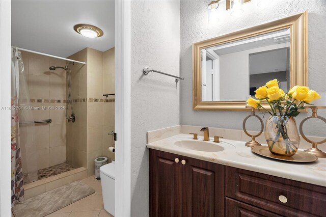 8401 SW 107th Ave Unit 117E, Miami, FL 33173 - full bathroom with a textured wall, toilet, vanity, tiled shower, and tile patterned flooring