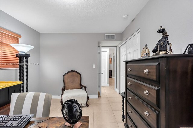 8401 SW 107th Ave Unit 117E, Miami, FL 33173 - living area featuring light tile patterned flooring, baseboards, and a textured ceiling