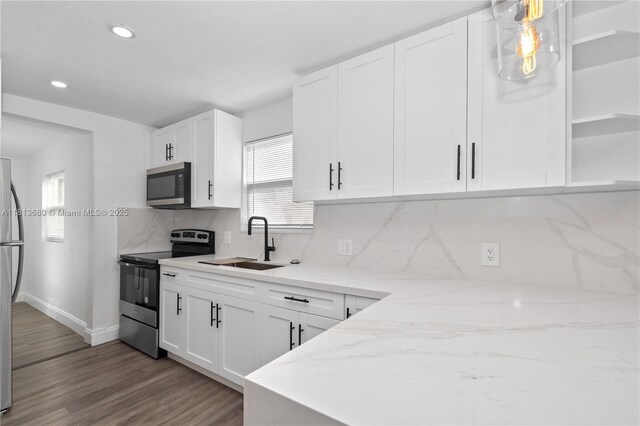 2374 NW 56th St, Miami, FL 33142 - kitchen featuring stainless steel appliances, a sink, healthy amount of natural light, backsplash, and recessed lighting