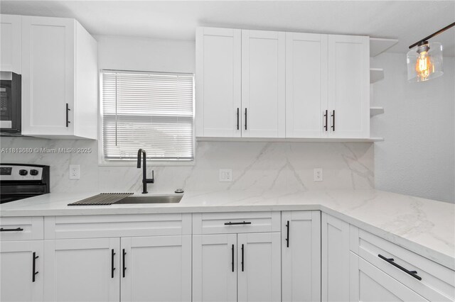 2374 NW 56th St, Miami, FL 33142 - kitchen with open shelves, a sink, tasteful backsplash, and white cabinetry