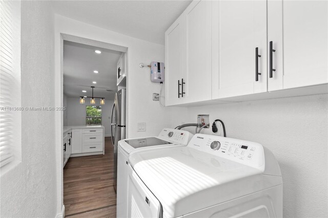 2374 NW 56th St, Miami, FL 33142 - washroom featuring washing machine and clothes dryer, cabinet space, dark wood-type flooring, and recessed lighting