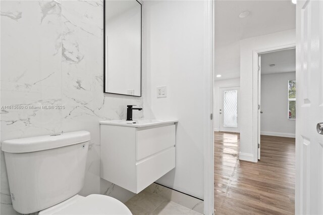 2374 NW 56th St, Miami, FL 33142 - bathroom with vanity, toilet, and wood finished floors