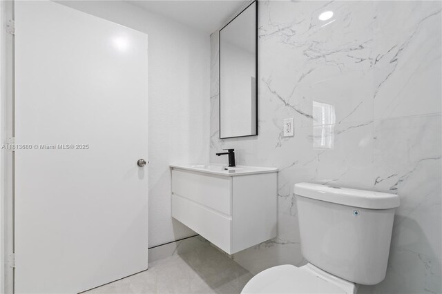 2374 NW 56th St, Miami, FL 33142 - bathroom featuring vanity, toilet, and marble finish flooring