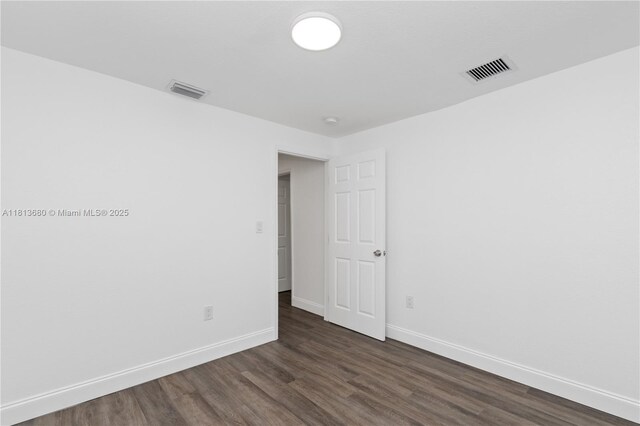 2374 NW 56th St, Miami, FL 33142 - empty room featuring dark wood finished floors and baseboards