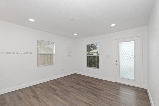2374 NW 56th St, Miami, FL 33142 - empty room with dark wood-type flooring, recessed lighting, and baseboards