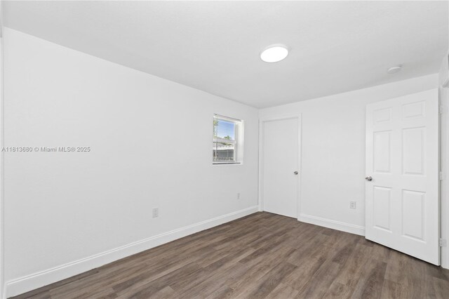 2374 NW 56th St, Miami, FL 33142 - unfurnished bedroom with wood finished floors and baseboards
