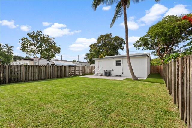 2374 NW 56th St, Miami, FL 33142 - view of yard featuring central AC unit and a patio