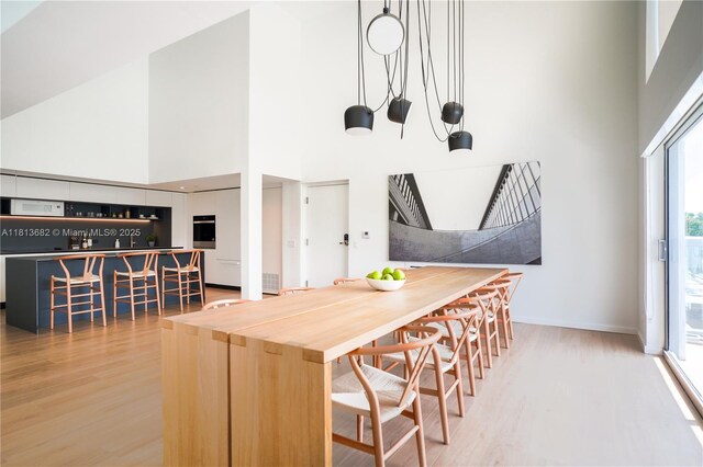 10250 Collins Ave Unit Ph1, Bal Harbour, FL 33154 - dining room with a towering ceiling and wood finished floors