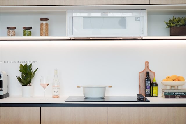 10250 Collins Ave Unit Ph1, Bal Harbour, FL 33154 - detailed view of white microwave, light brown cabinets, and light countertops