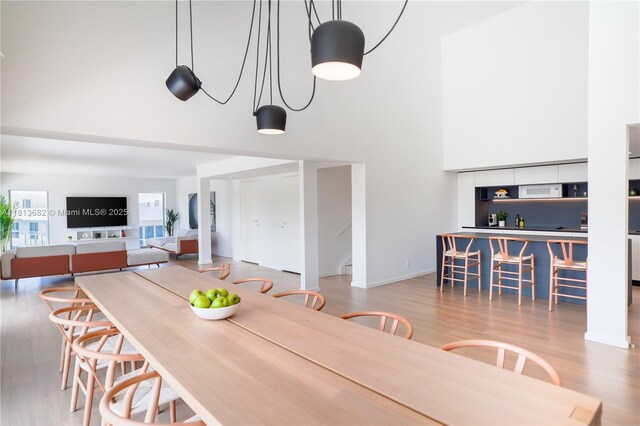 10250 Collins Ave Unit Ph1, Bal Harbour, FL 33154 - dining area featuring a towering ceiling and wood finished floors