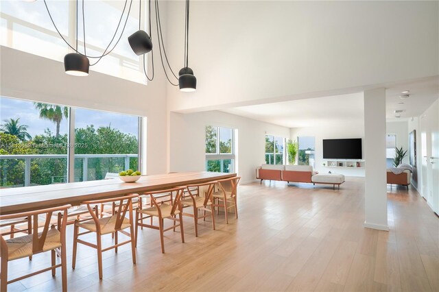 10250 Collins Ave Unit Ph1, Bal Harbour, FL 33154 - dining space with light wood-type flooring and a high ceiling