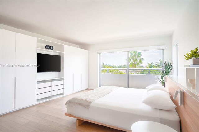 10250 Collins Ave Unit Ph1, Bal Harbour, FL 33154 - bedroom with light wood-style flooring