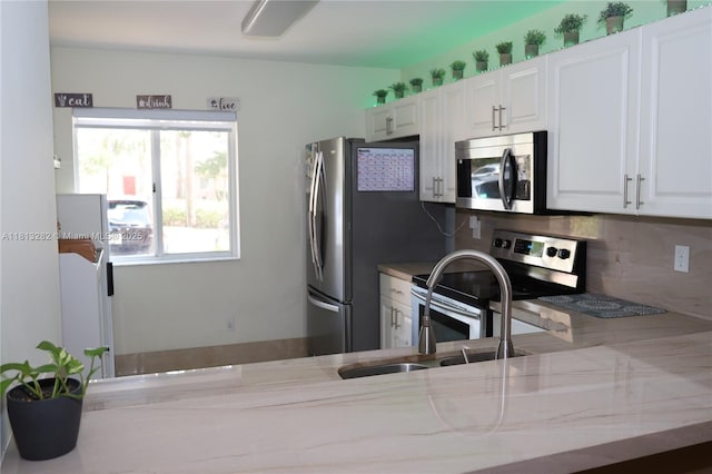 20816 NW 2nd St, Pembroke Pines, FL 33029 - kitchen featuring stainless steel appliances, a sink, white cabinets, and backsplash