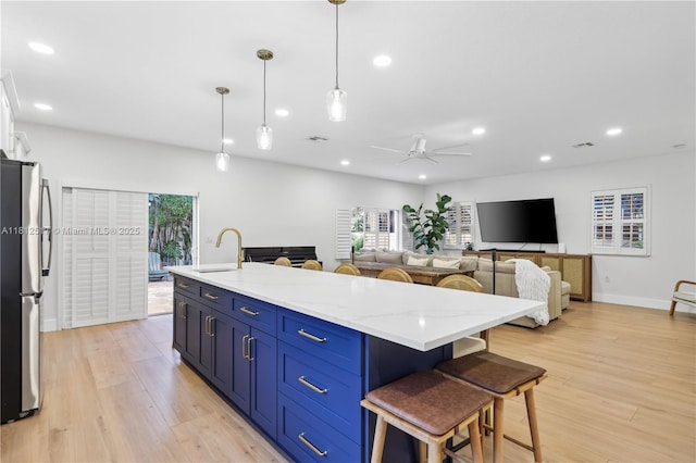 3229 Canal Dr, Pompano Beach, FL 33062 - kitchen with freestanding refrigerator, healthy amount of natural light, a ceiling fan, a kitchen breakfast bar, and recessed lighting